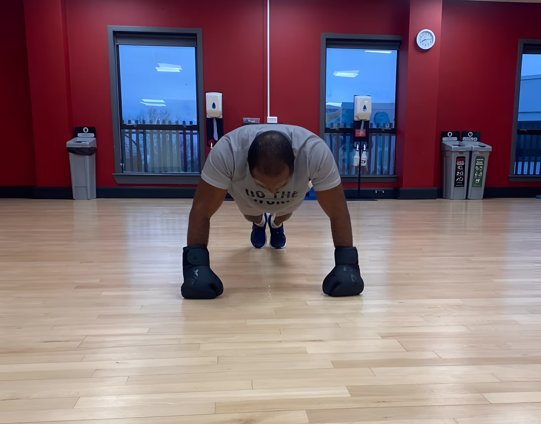 Client at the top of a long plank exercise in the gym.